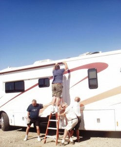 How many RVers does it take to secure a slide awning in a wind storm?